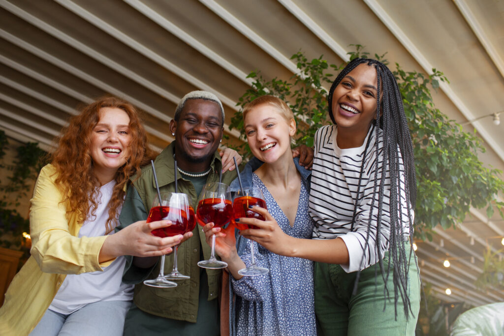 A group of friends enjoying the detty december with cocktails.