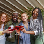 A group of friends enjoying the detty december with cocktails.