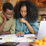 Young couple calculating new year budget